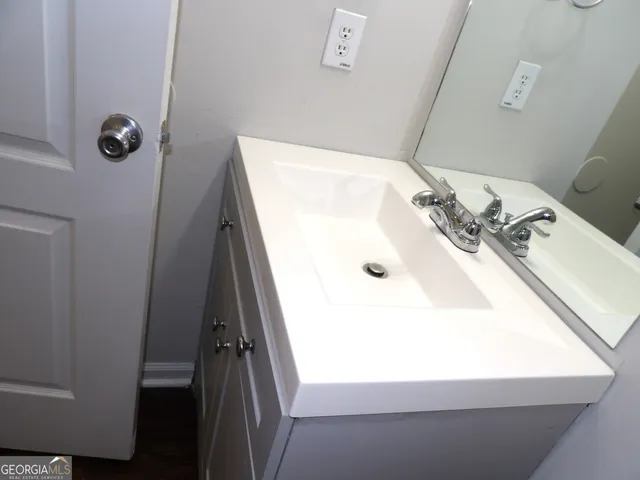 a bathroom with a sink and mirror