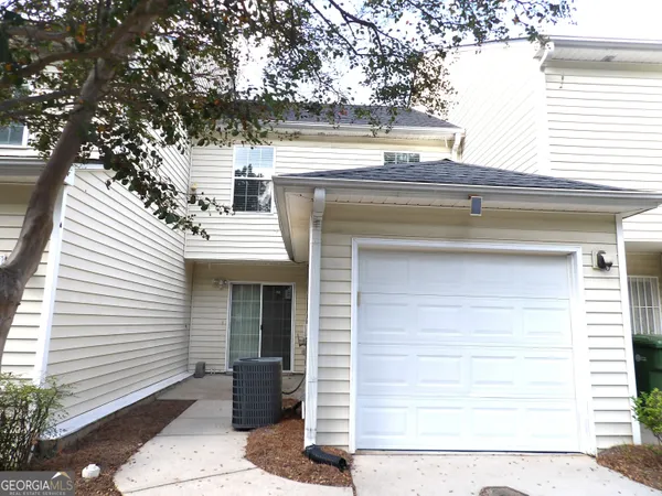 a view of a house with a tree
