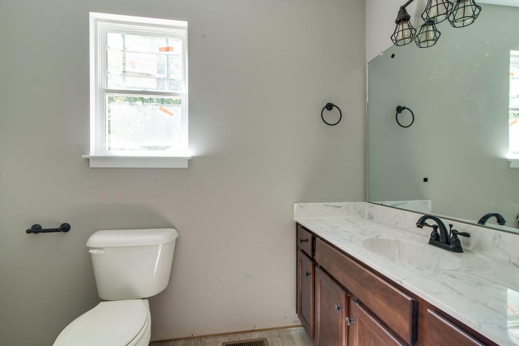 234 East Piney Road Dickson, TN 37055 - Photo 15 of 18 a bathroom with a granite countertop toilet sink and mirror