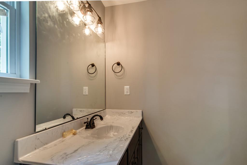 234 East Piney Road Dickson, TN 37055 - Photo 16 of 18 a bathroom with a granite countertop sink and a mirror