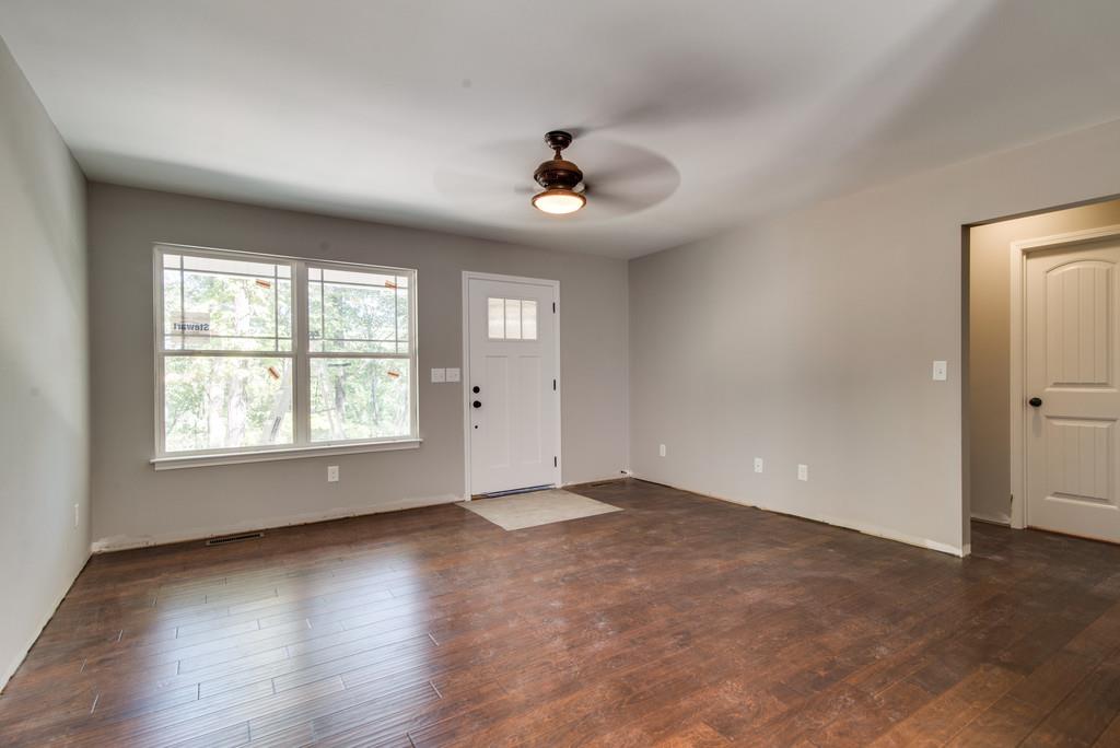234 East Piney Road Dickson, TN 37055 - Photo 4 of 18 an empty room with wooden floor ceiling fan and windows