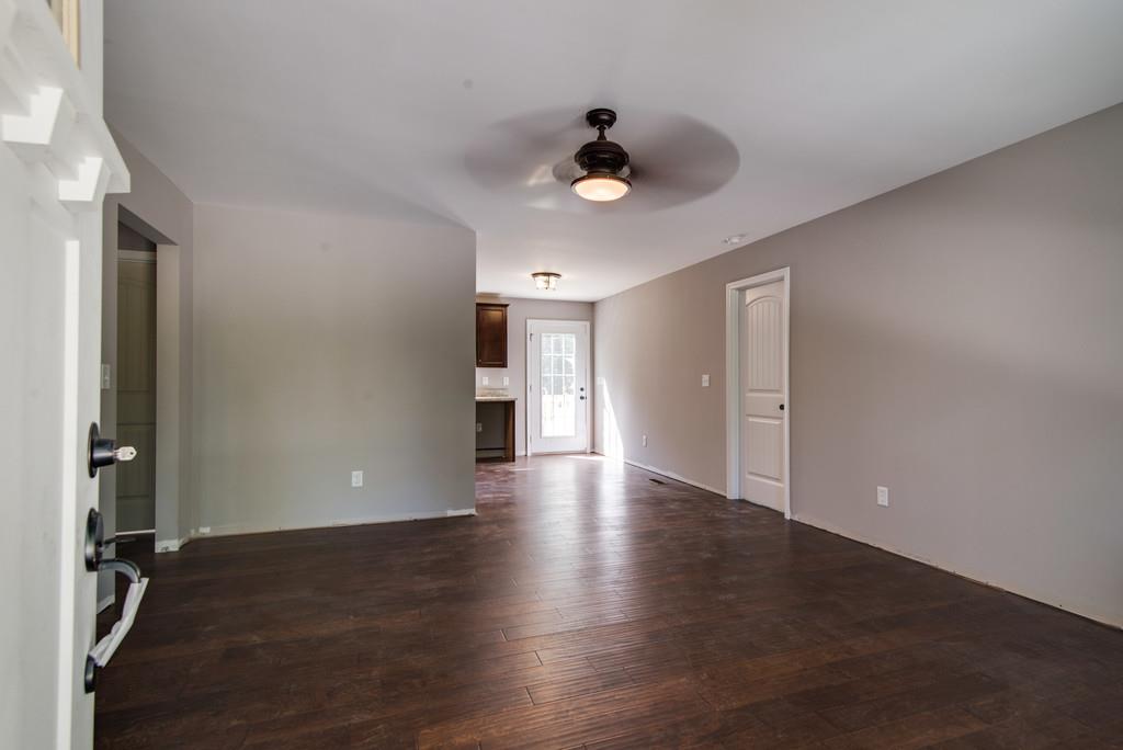234 East Piney Road Dickson, TN 37055 - Photo 5 of 18 a view of an empty room with wooden floor and a ceiling fan