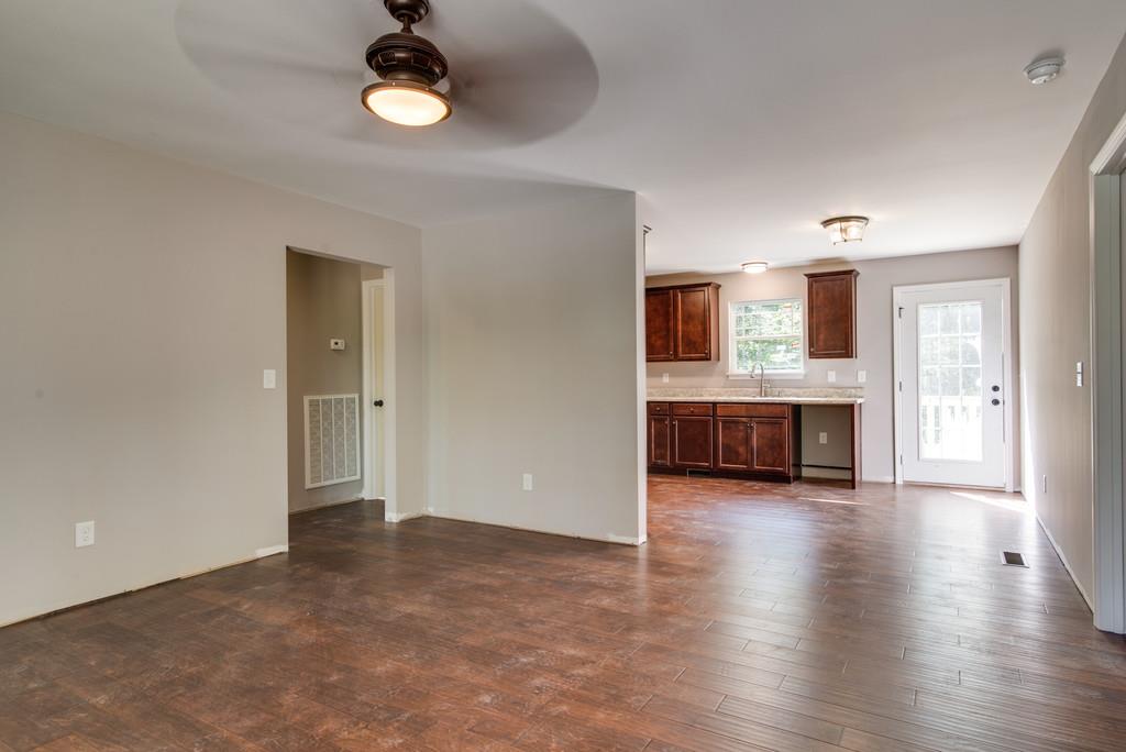 234 East Piney Road Dickson, TN 37055 - Photo 6 of 18 an empty room with a kitchen and fireplace