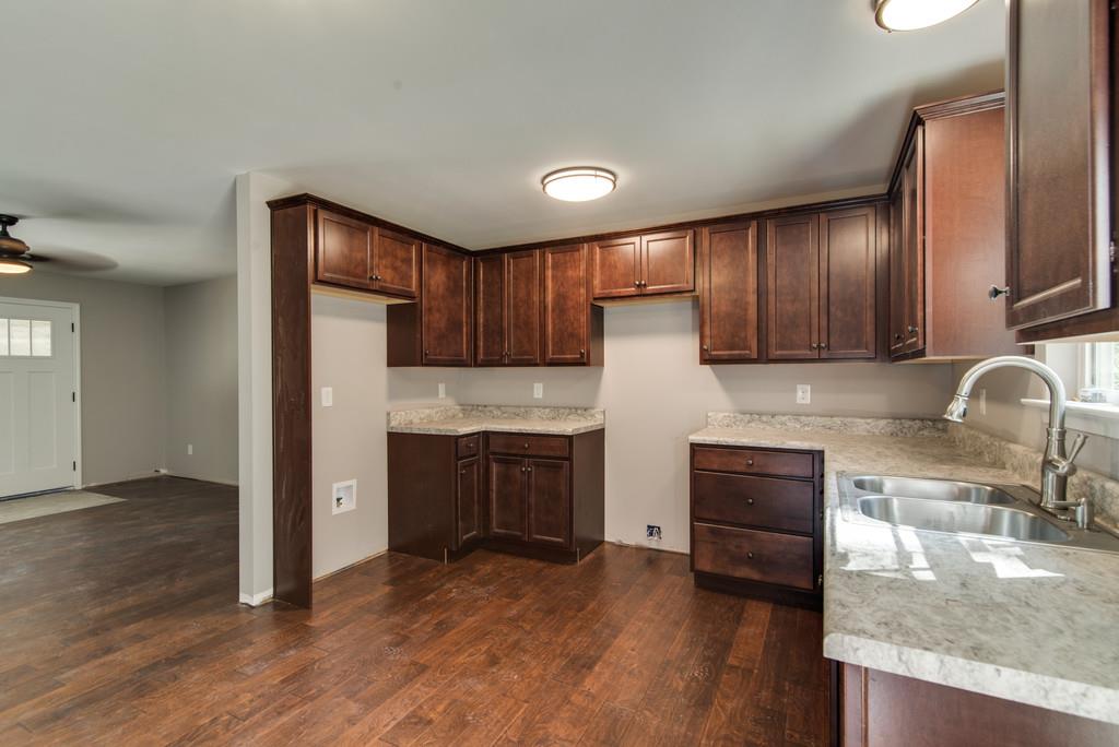 234 East Piney Road Dickson, TN 37055 - Photo 8 of 18 a kitchen with granite countertop a stove a sink and a refrigerator