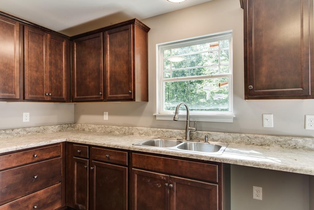 234 East Piney Road Dickson, TN 37055 - Photo 10 of 18 a kitchen with a sink and wooden cabinets