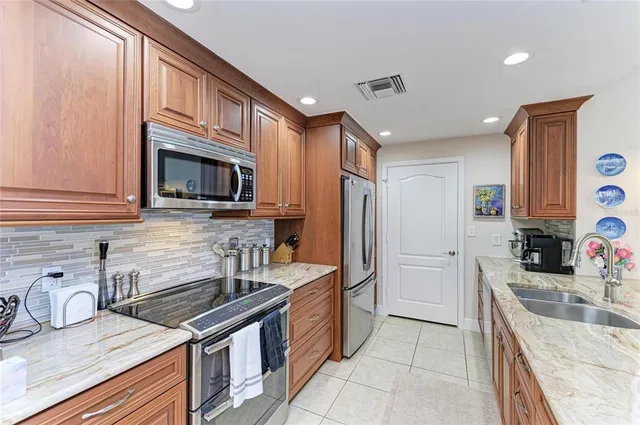 a living room with furniture and a view of kitchen