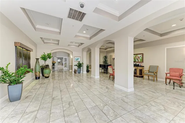 a view of a hallway to a livingroom with furniture and mirror