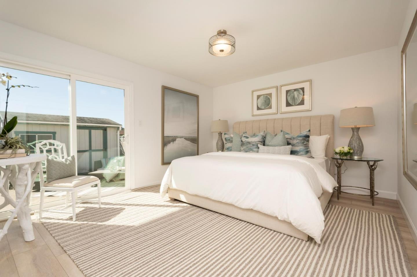 150 Surf Street Pacifica, CA 94044 - Photo 11 of 20 a bedroom with a bed and wooden floor