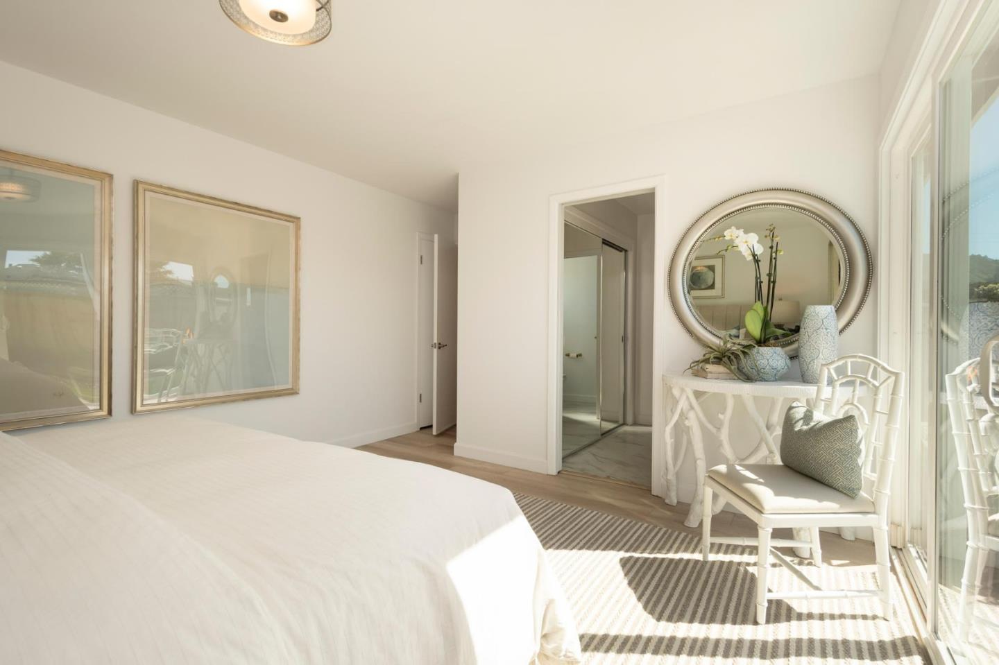 150 Surf Street Pacifica, CA 94044 - Photo 12 of 20 a bedroom with a bed and a mirror