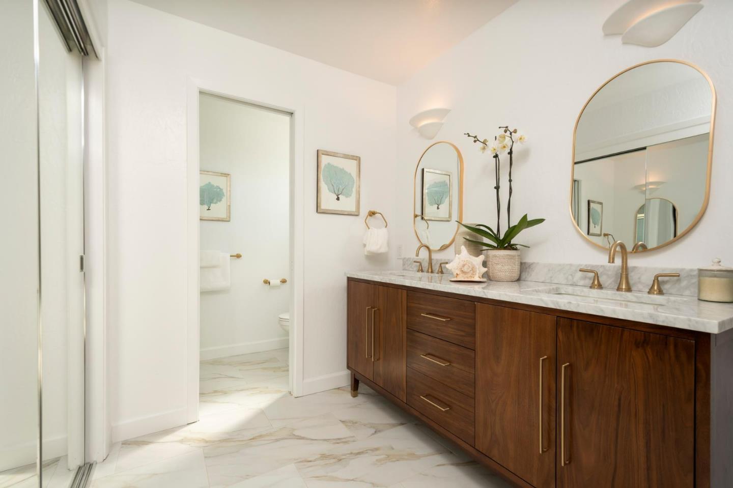150 Surf Street Pacifica, CA 94044 - Photo 13 of 20 a bathroom with double vanity sinks and a mirror