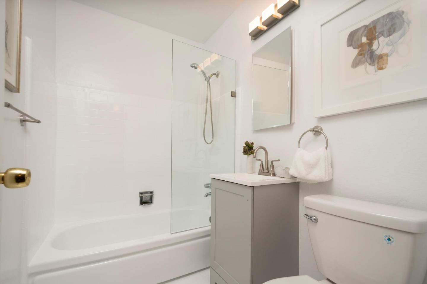 150 Surf Street Pacifica, CA 94044 - Photo 16 of 20 a bathroom with a sink a toilet and shower