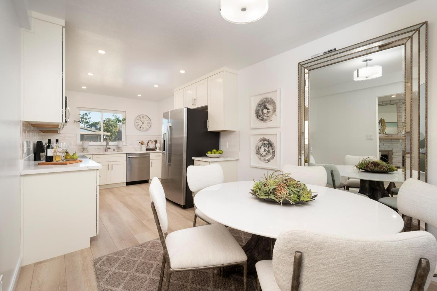150 Surf Street Pacifica, CA 94044 - Photo 5 of 20 a kitchen with stainless steel appliances a dining table and chairs