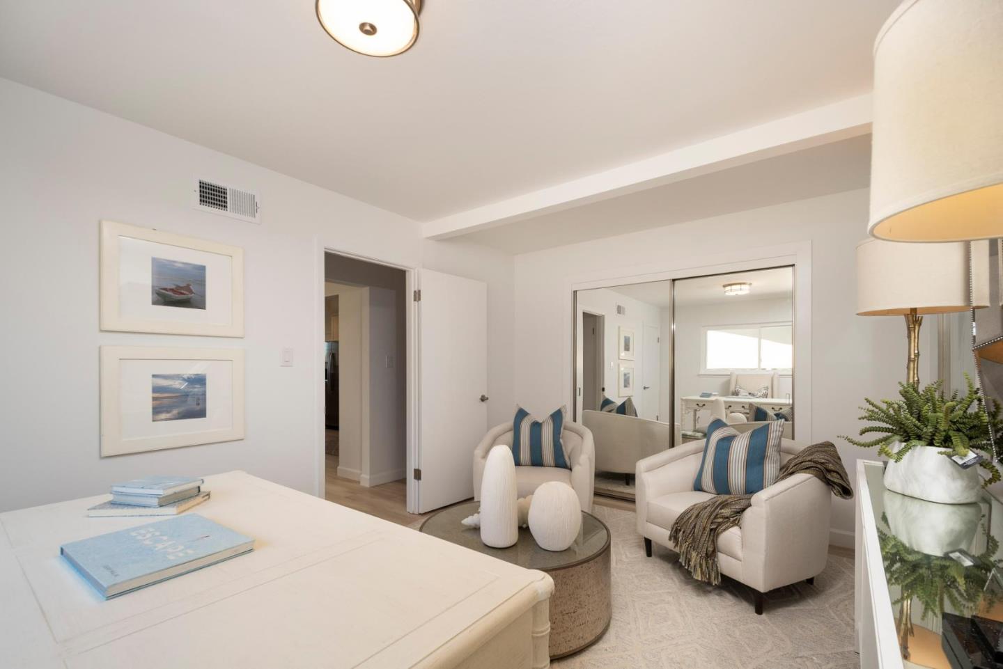 150 Surf Street Pacifica, CA 94044 - Photo 10 of 20 a bedroom with furniture and a potted plant