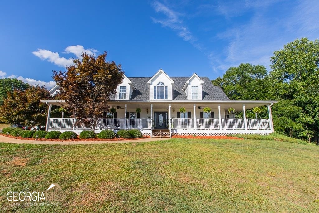 3843 New Kings Bridge Road Nicholson, GA 30565 - Photo 1 of 1 a front view of a house with a yard table and chairs