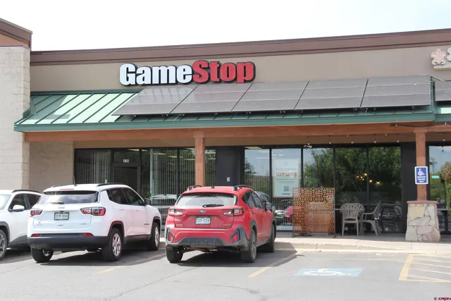 a front view of building with cars