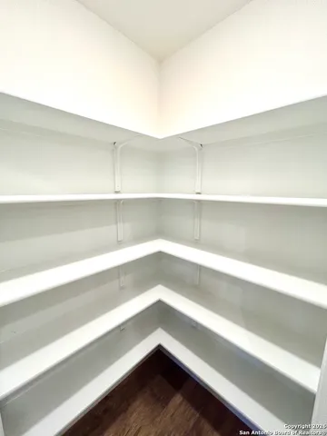 a view of storage and utility room with wooden floor