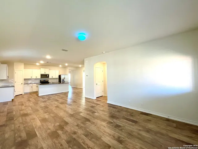 a view of a kitchen with a sink and a refrigerator