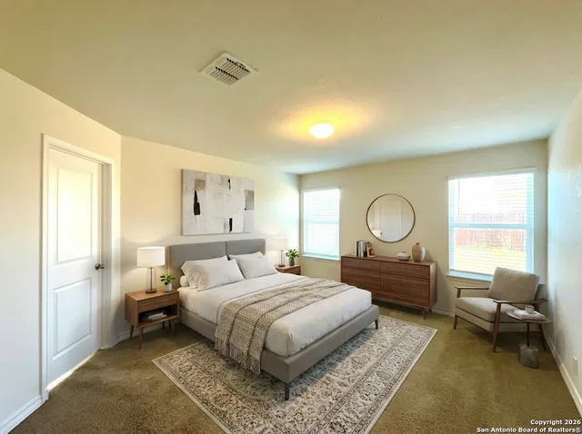 a bedroom with a bed a mirror and a window