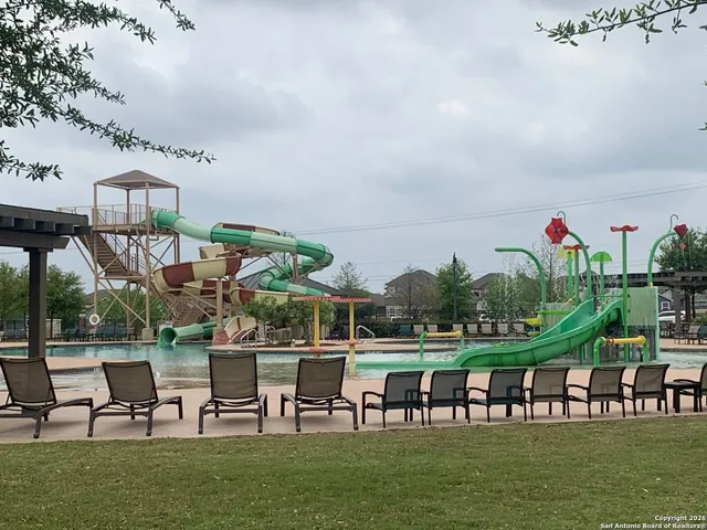 a view of a chairs and table in a patio with a yard