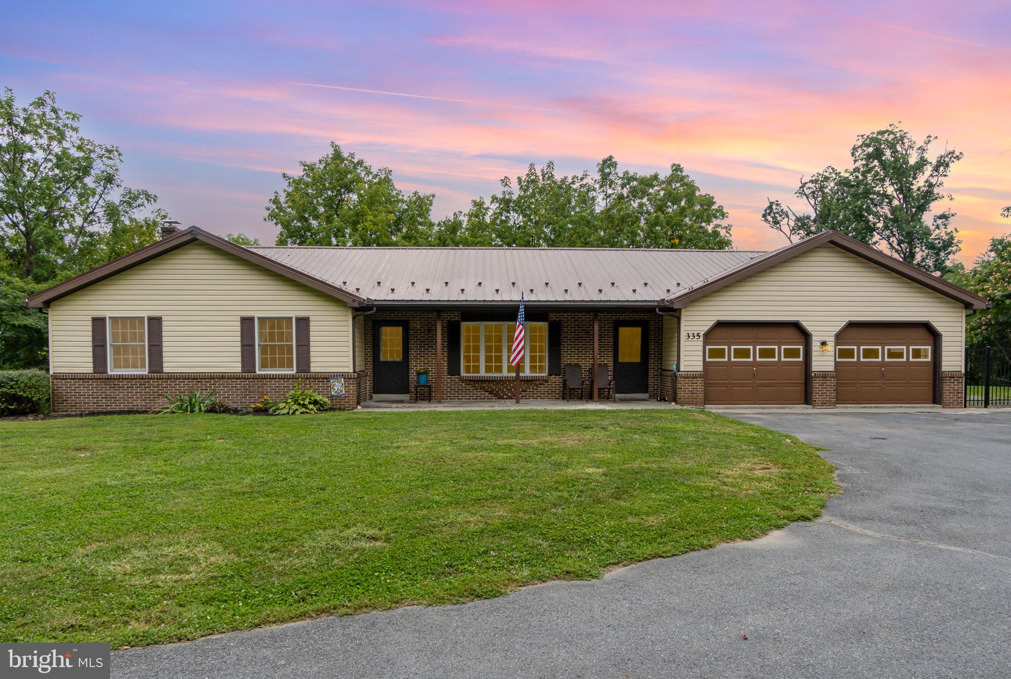 335 Apple Ridge Road Loysville, PA 17047 - Photo 1 of 46 a front view of a house with a garden and yard