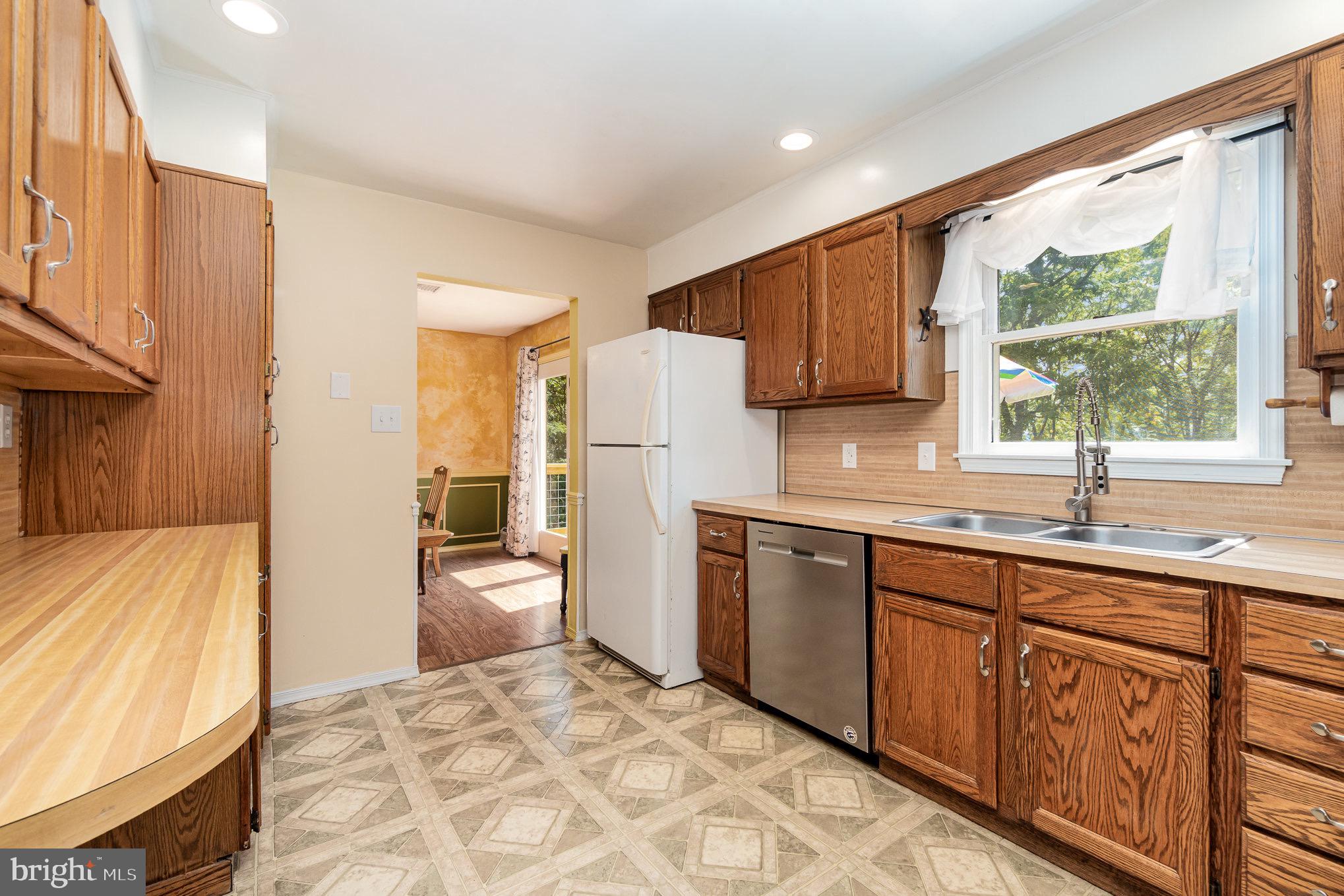 335 Apple Ridge Road Loysville, PA 17047 - Photo 11 of 46 a kitchen with granite countertop wooden cabinets a sink a window and stainless steel appliances