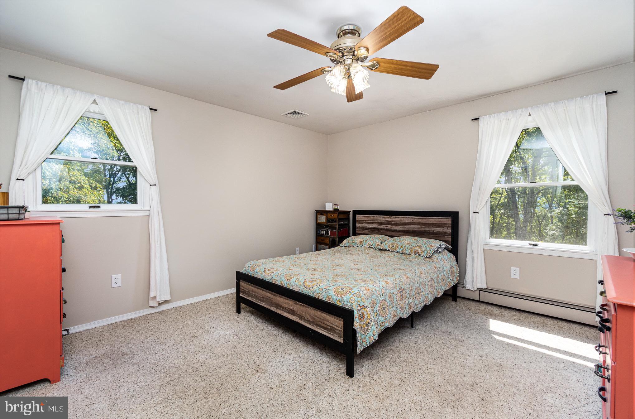 335 Apple Ridge Road Loysville, PA 17047 - Photo 15 of 46 a spacious bedroom with a bed and a large window