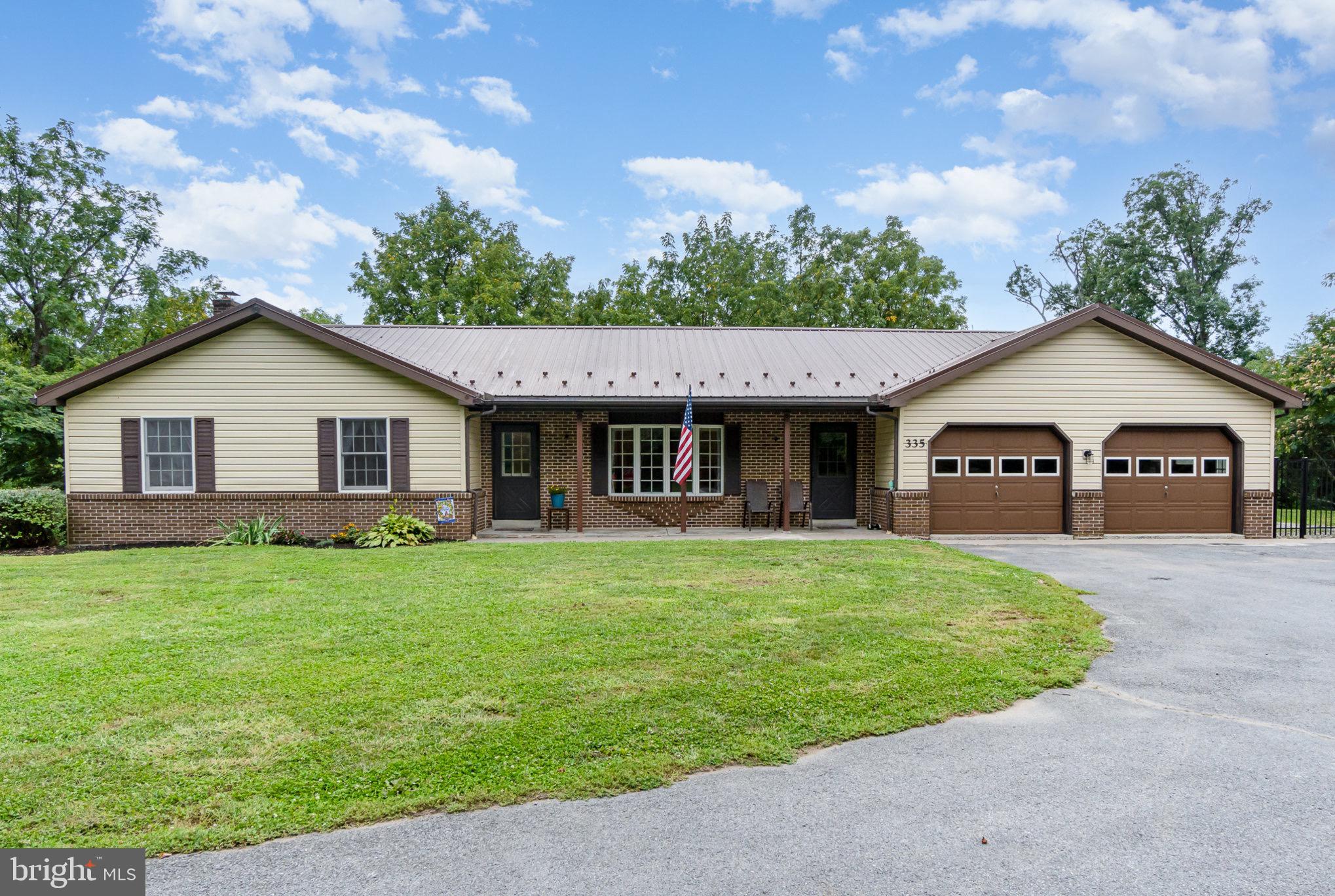 335 Apple Ridge Road Loysville, PA 17047 - Photo 4 of 46 a front view of a house with a garden and yard