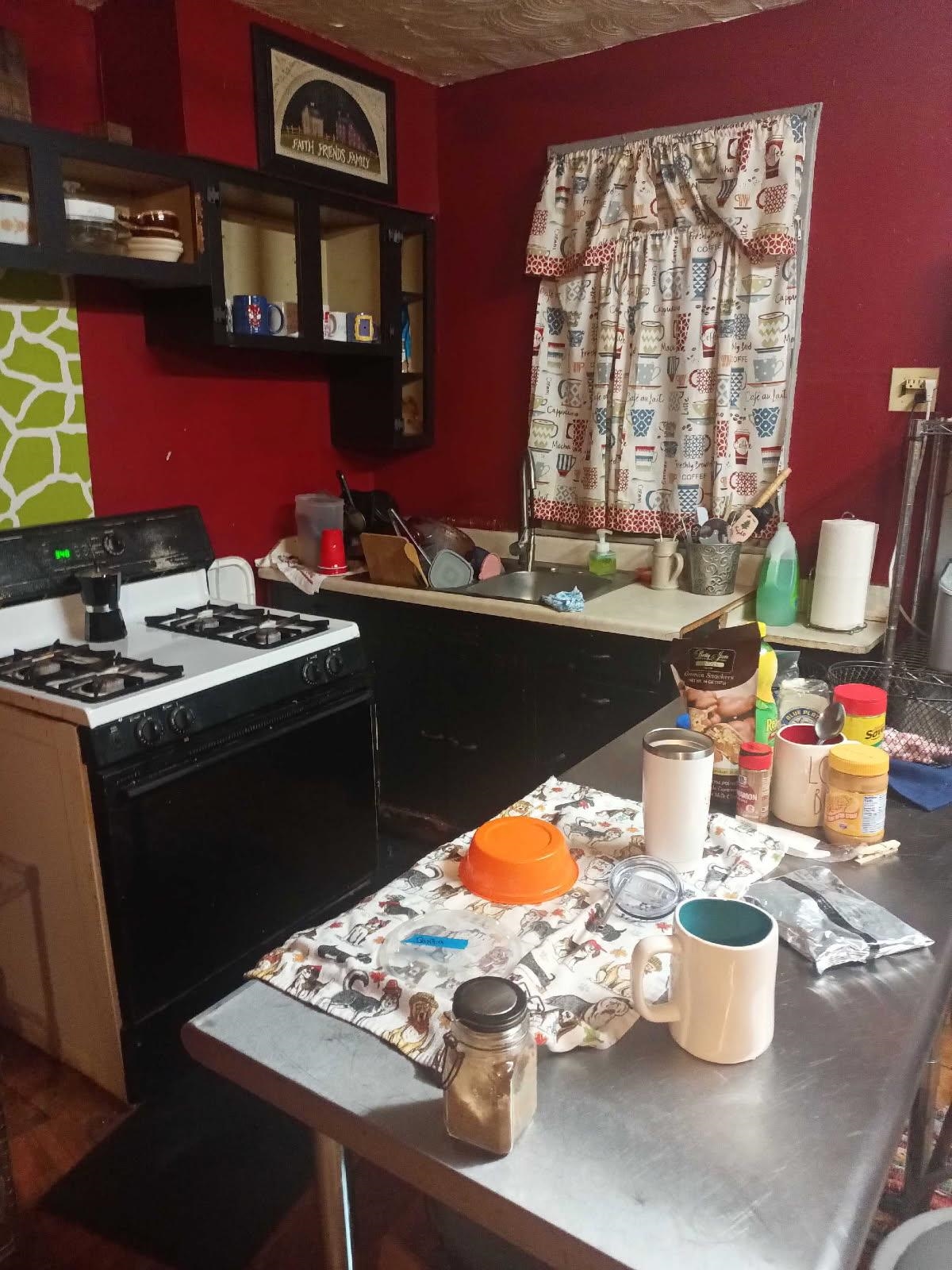 249 Caldwell Avenue Memphis, TN 38107 - Photo 11 of 22 a kitchen with a sink stove and wooden cabinets