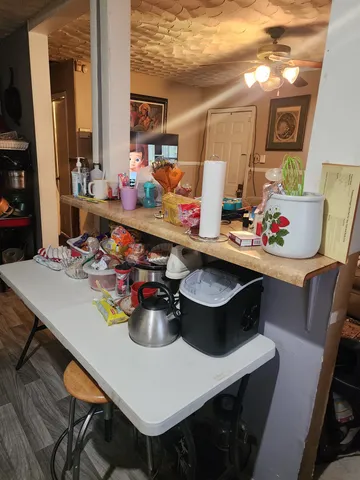 a view of a dining room with furniture and a chandelier