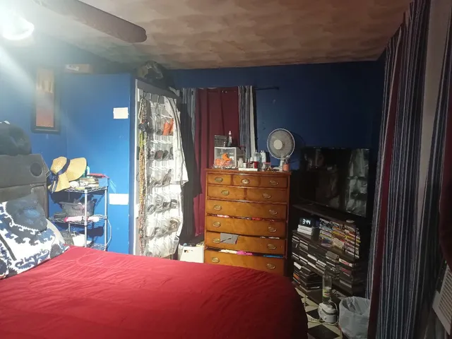 a bedroom with a bed and a closet with mirror