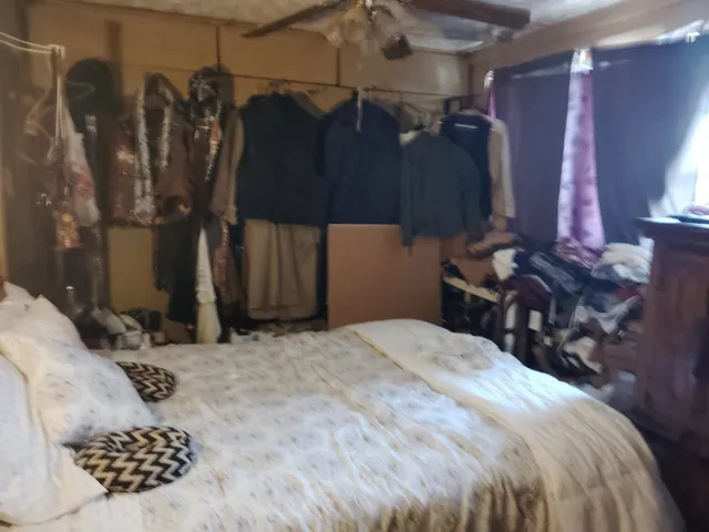 a bed room with a bed and a chair