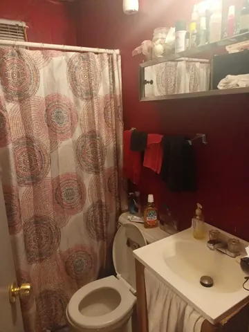 a bathroom with a sink mirror vanity and toilet