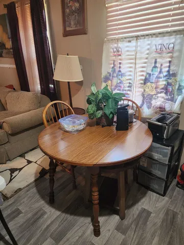 a view of a dining room with furniture and window