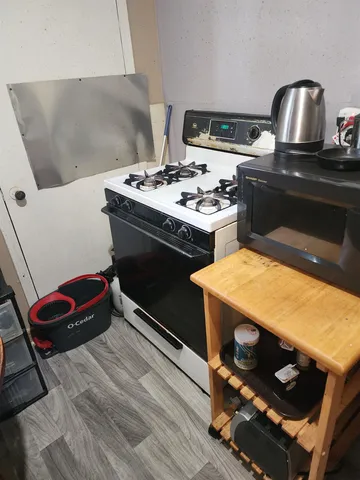 a kitchen with a stove and a sink
