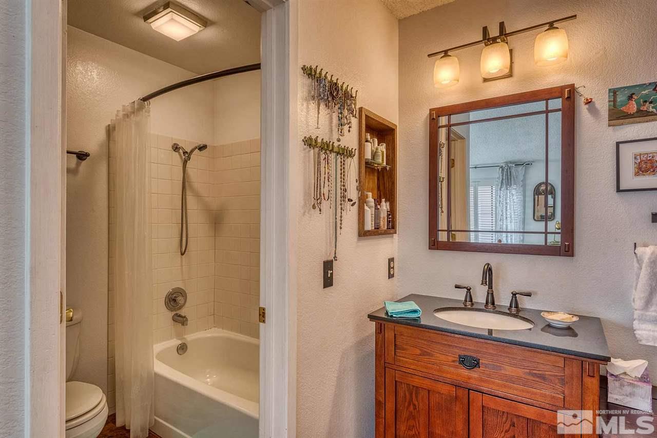 2875 Idlewild Drive, Unit 58 Reno, NV 89509 - Photo 13 of 25 a bathroom with a granite countertop sink toilet and shower