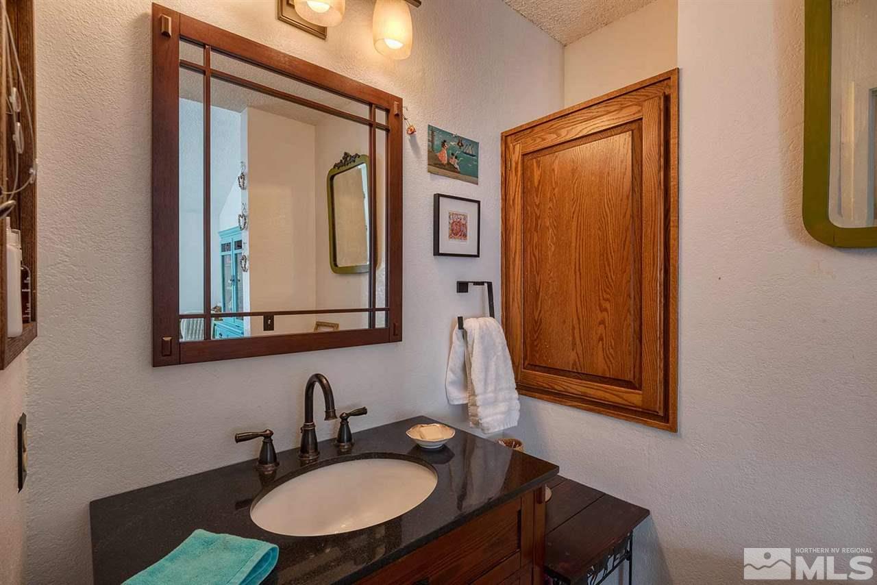2875 Idlewild Drive, Unit 58 Reno, NV 89509 - Photo 14 of 25 a bathroom with a sink mirror and a toilet