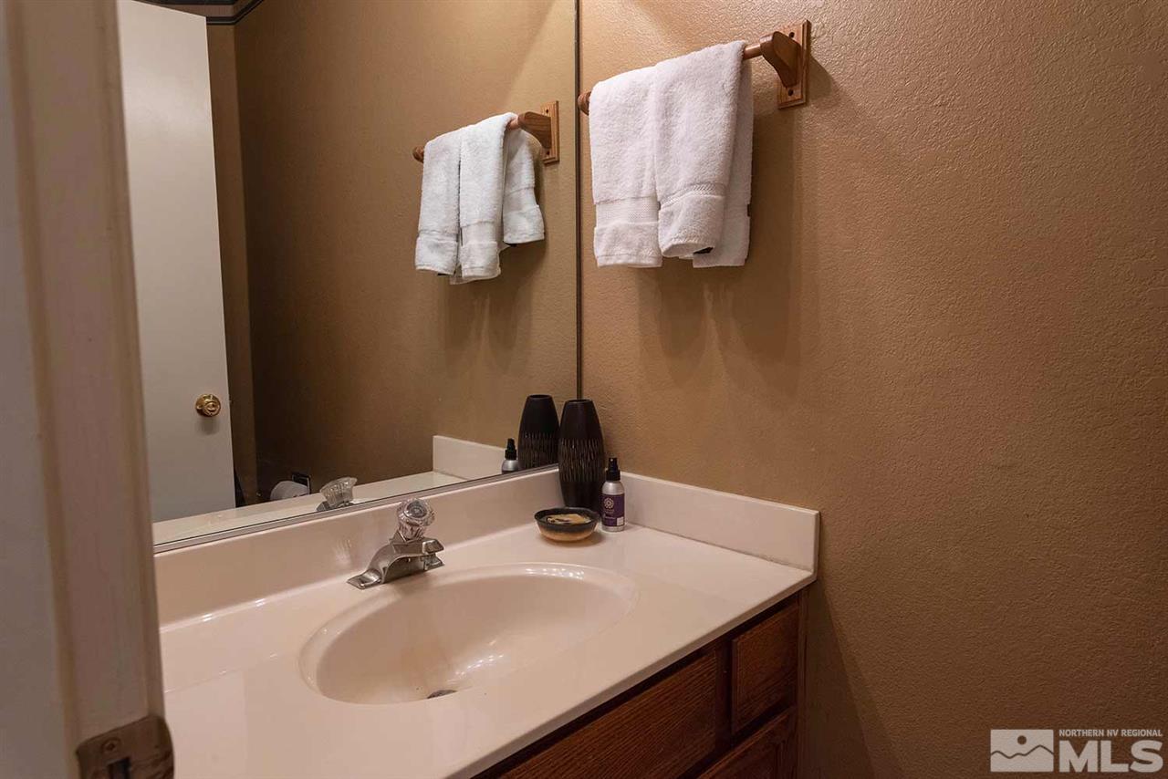 2875 Idlewild Drive, Unit 58 Reno, NV 89509 - Photo 18 of 25 a bathroom with a sink and mirror