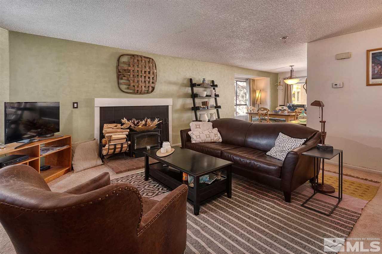 2875 Idlewild Drive, Unit 58 Reno, NV 89509 - Photo 4 of 25 a living room with furniture and a flat screen tv