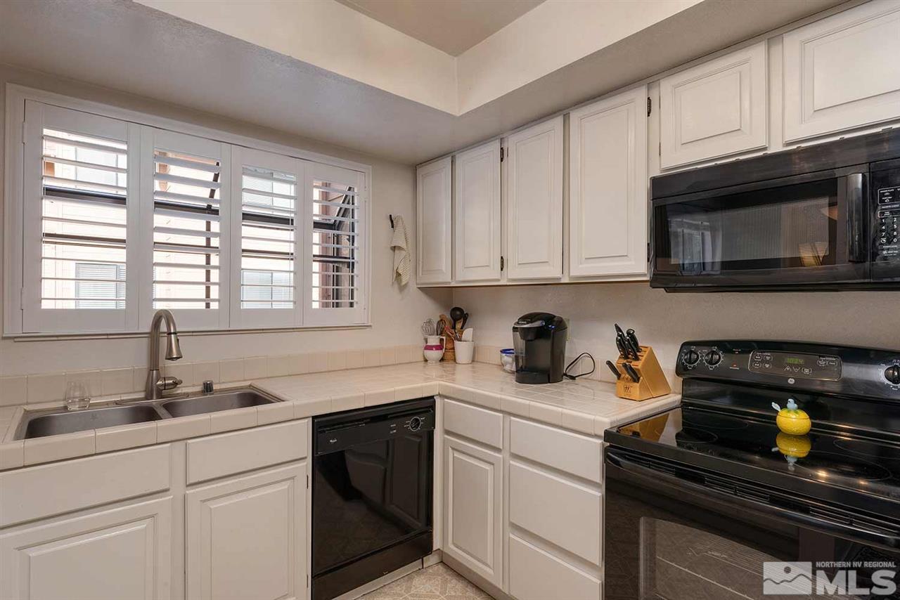2875 Idlewild Drive, Unit 58 Reno, NV 89509 - Photo 9 of 25 a kitchen with sink cabinets and window