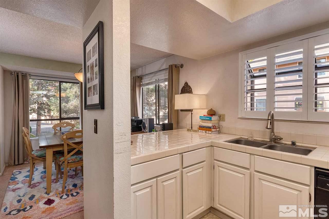 2875 Idlewild Drive, Unit 58 Reno, NV 89509 - Photo 10 of 25 a kitchen with a sink stove and cabinets