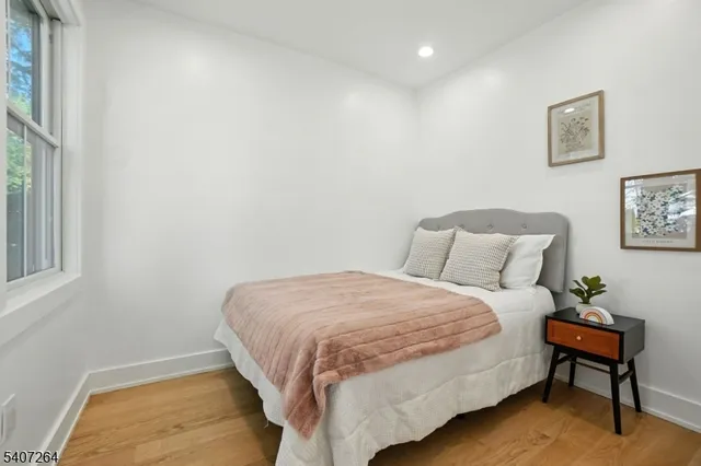 a bedroom with a bed and a chair