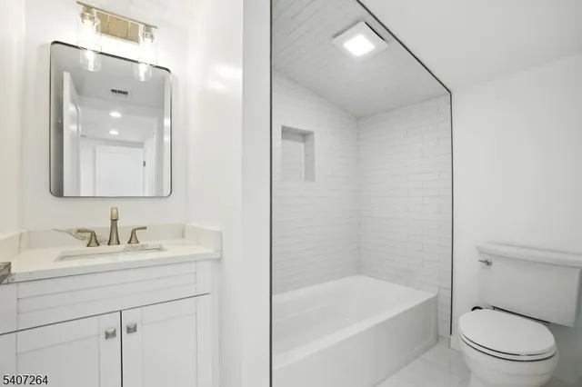 a bathroom with a sink a toilet and bathtub