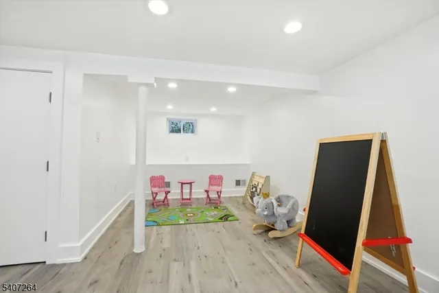 a hallway with furniture and wooden floor