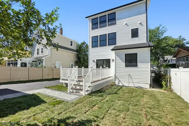 a white house with a large window and yard