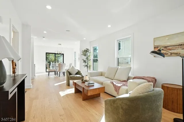a living room with furniture wooden floor and a flat screen tv