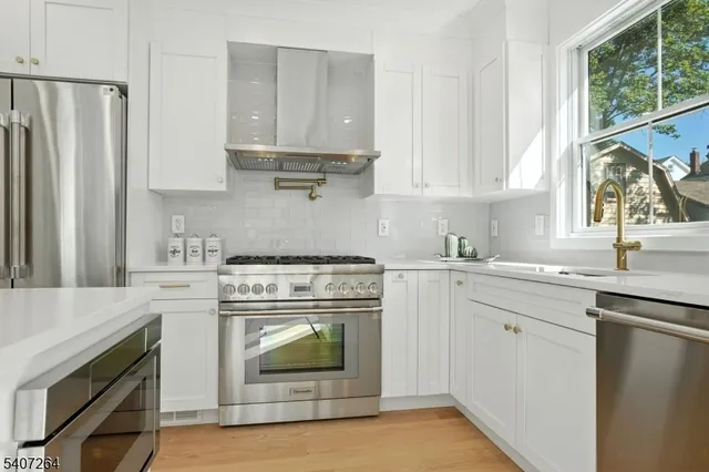 a kitchen with appliances cabinets and a sink