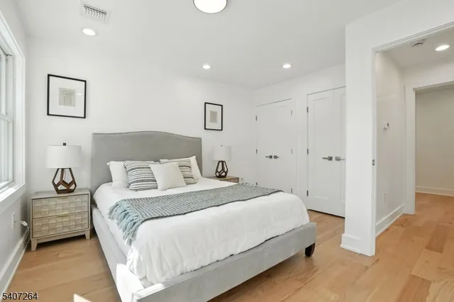 a spacious bedroom with a bed and a couch