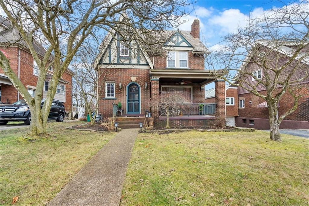 a view of a house with a yard covered with snow