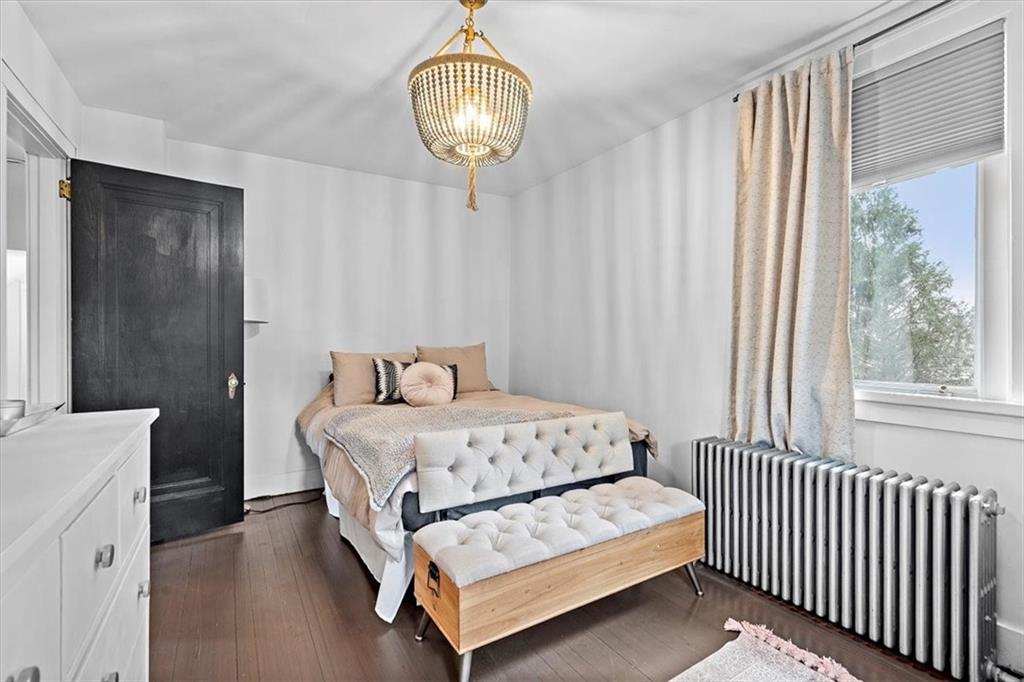 215 Elm Road Ambridge, PA 15003 - Photo 20 of 25 a spacious bedroom with a bed and a chandelier