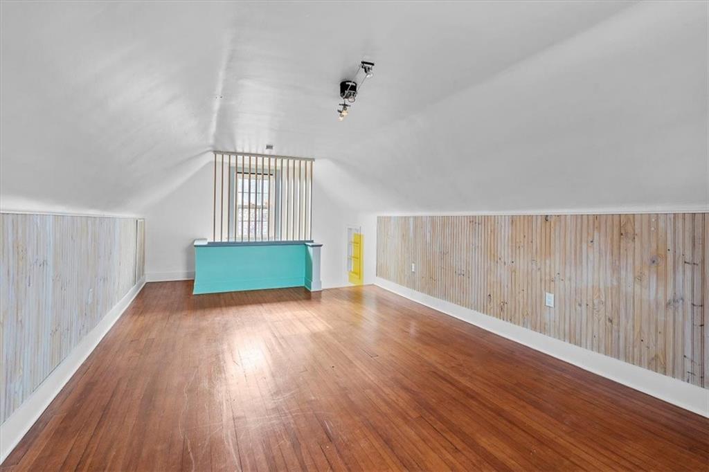 215 Elm Road Ambridge, PA 15003 - Photo 22 of 25 a view of an empty room with wooden floor and a window